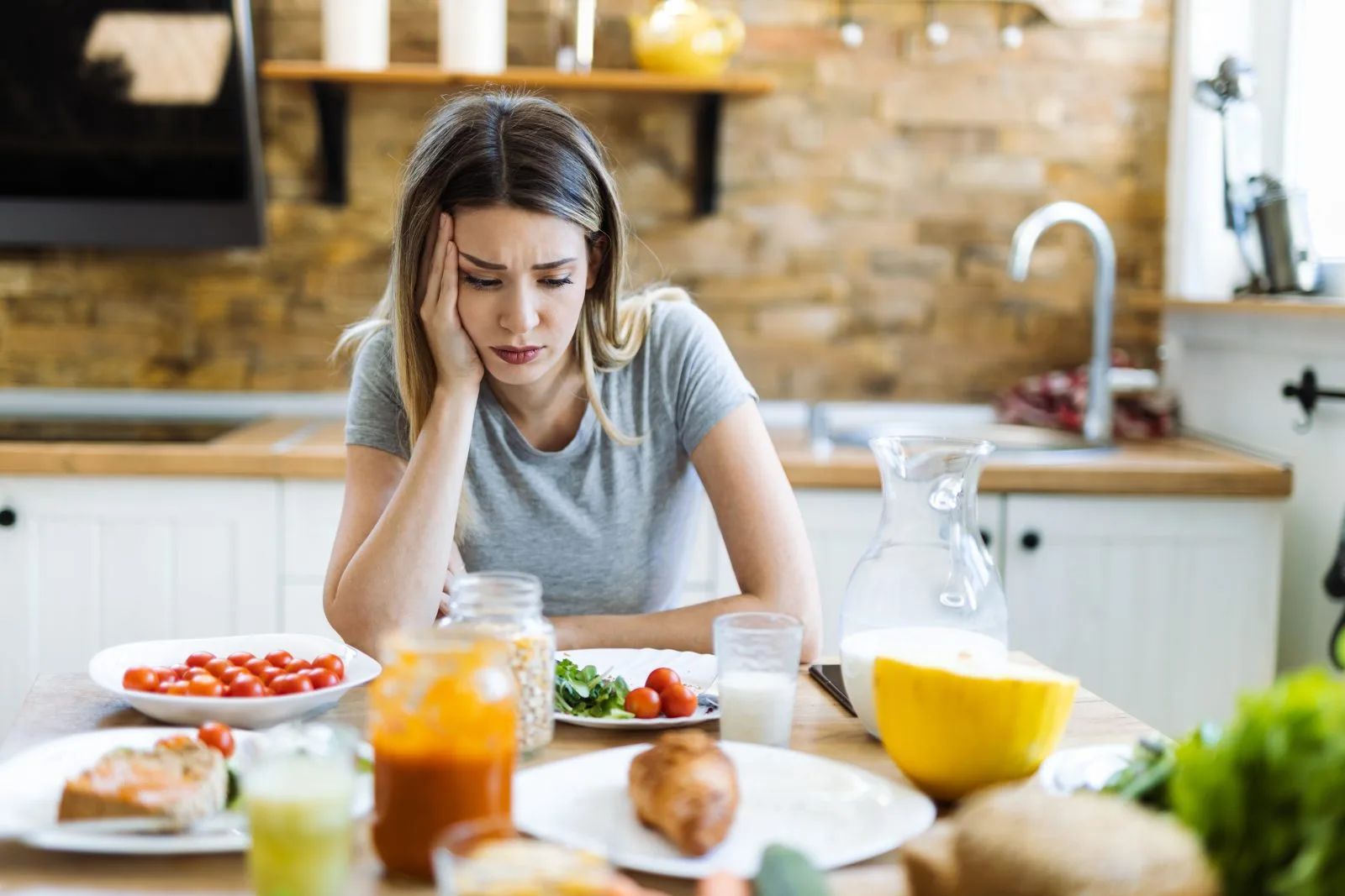 Woman stressed at the breakfast table – online psychiatry in Bend, OR